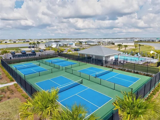 View of tennis court featuring a residential view