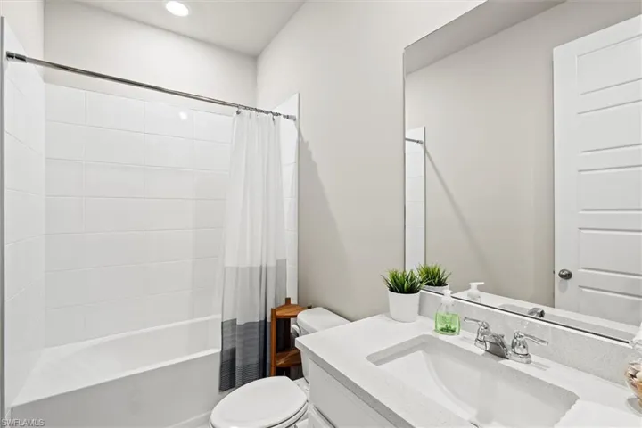 Full bath featuring shower / bath combo and vanity
