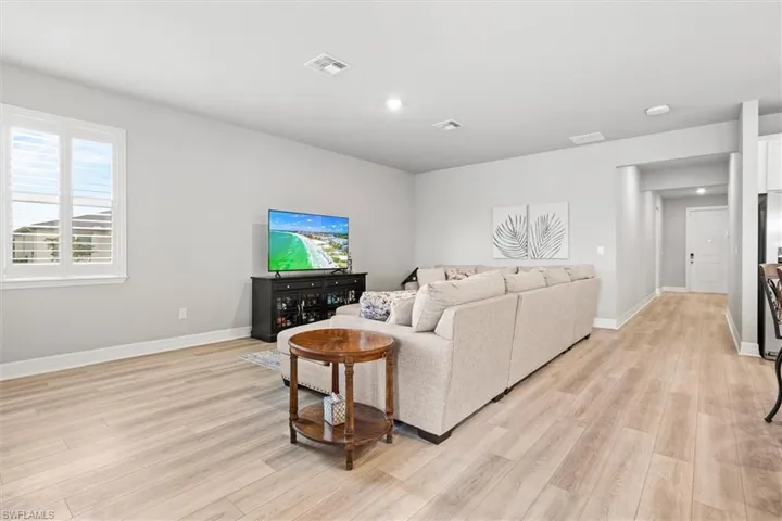 Living room featuring vinyl plank flooring and baseboards