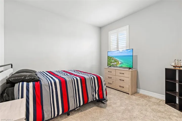 Carpeted bedroom featuring baseboards