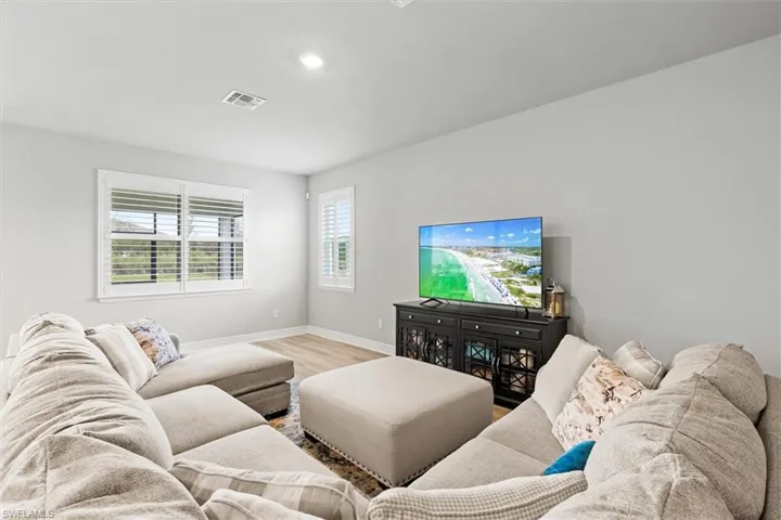 Living area featuring vinyl plank floors and recessed lighting