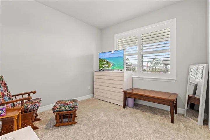 Sitting room with light carpet and baseboards