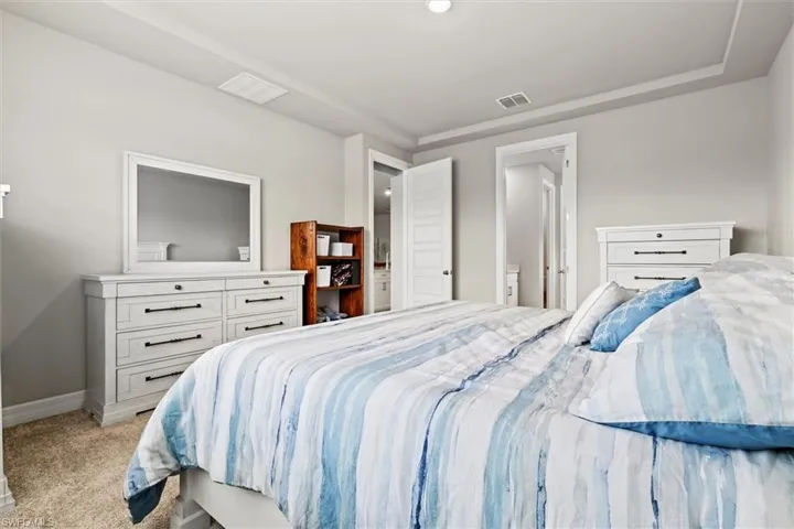 Bedroom featuring carpet and ensuite bath