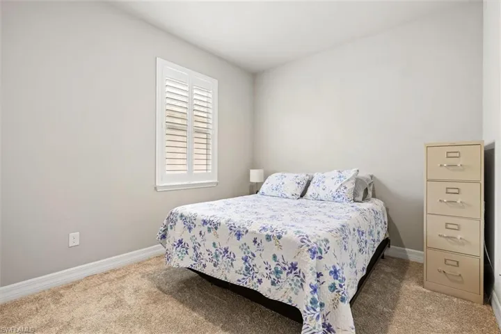 Carpeted bedroom featuring baseboards