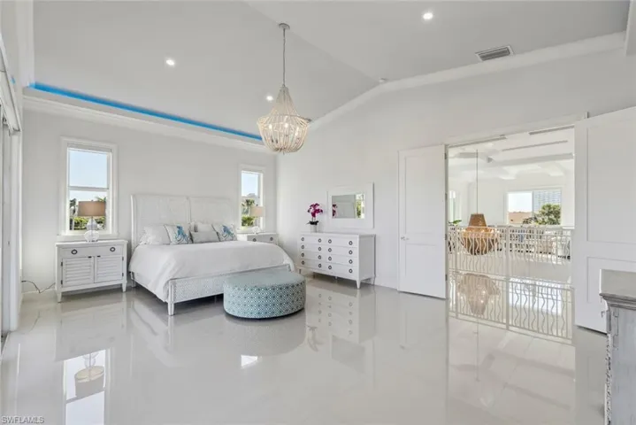Tiled bedroom featuring recessed lighting, visible vents, an inviting chandelier, and vaulted ceiling