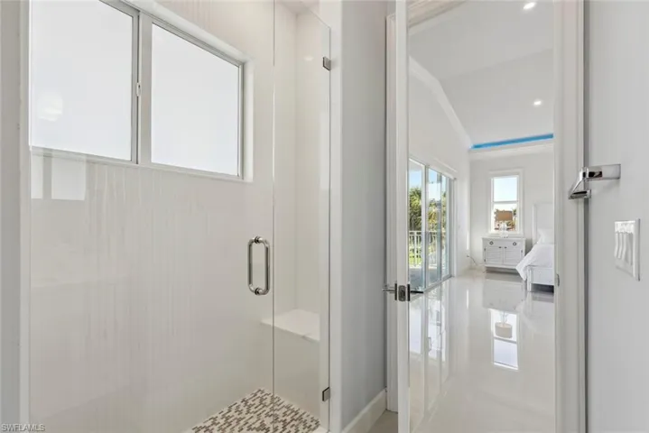 Ensuite bathroom with a stall shower, ensuite bathroom, and ornamental molding
