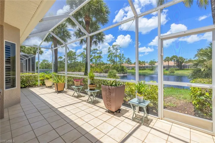 Sunroom / solarium featuring a water view