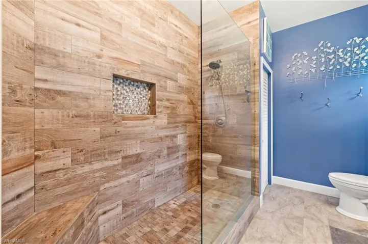 Bathroom featuring toilet and a walk in shower