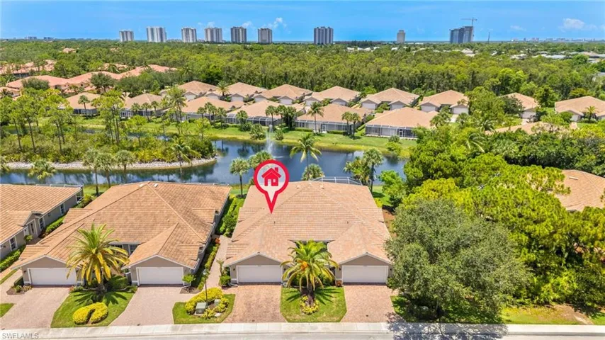 Aerial view of residential area featuring a nearby body of water