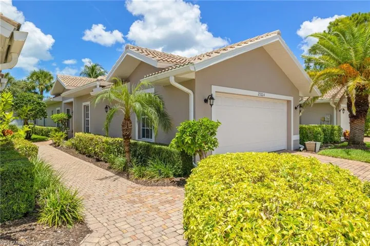 View of property exterior with stucco siding, a garage, and a tile roof
