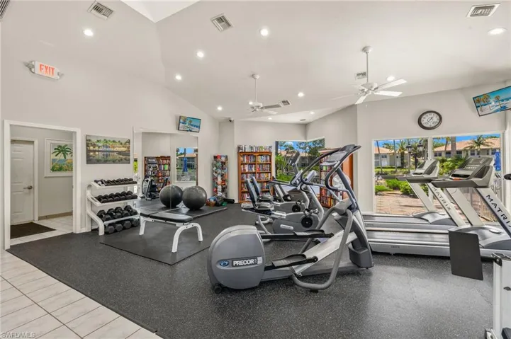 Gym featuring recessed lighting, ceiling fan, and high vaulted ceiling