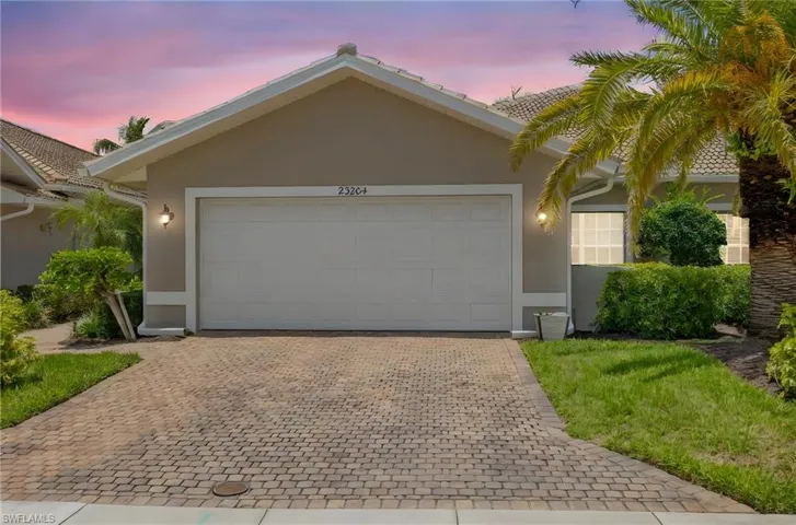 Ranch-style house with stucco siding, driveway, and a garage