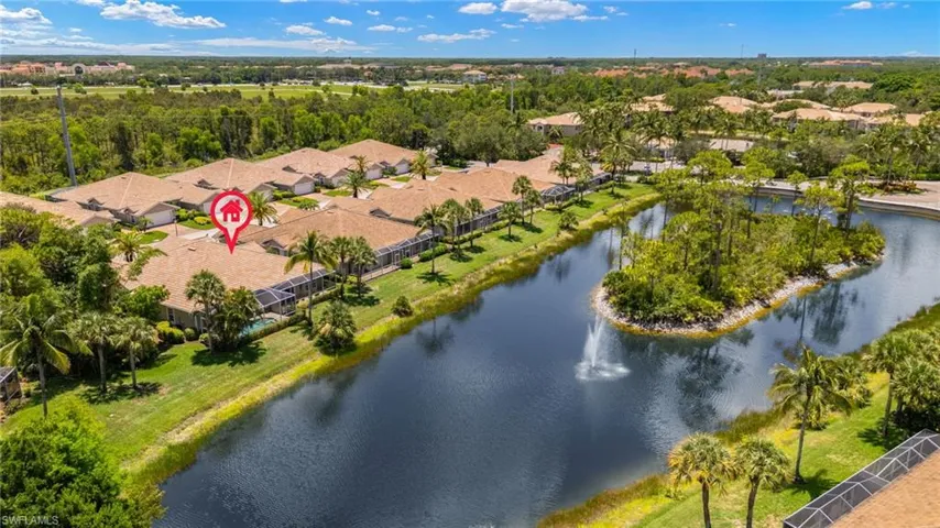 Aerial view of residential area featuring a nearby body of water