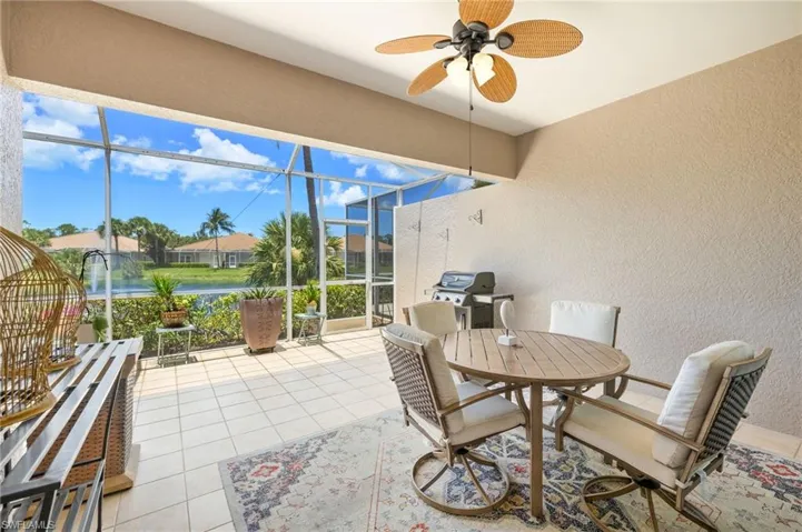 Sunroom / solarium with ceiling fan and outdoor dining space