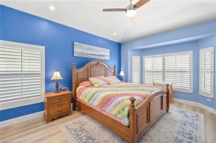 Bedroom featuring light wood-style floors, ceiling fan, and recessed lighting