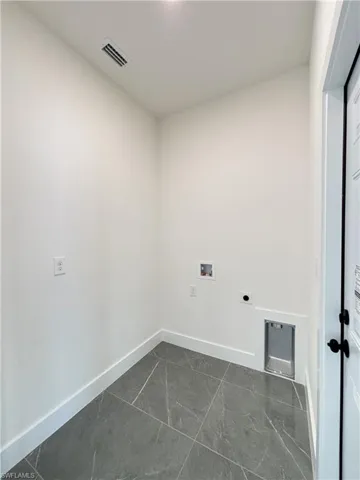 Laundry room featuring hookup for a washing machine, electric dryer hookup, and baseboards