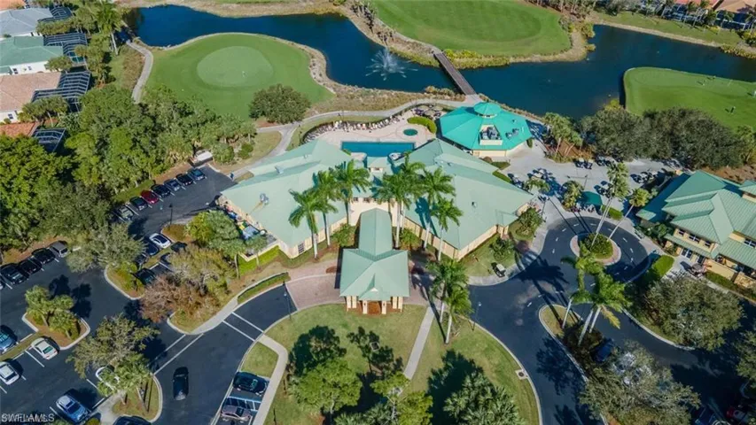 Birds eye view of property with golf course view, a water view, and a residential view