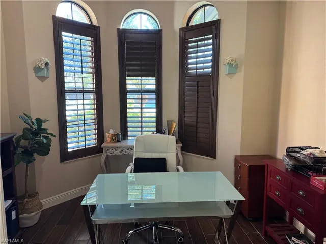 Office featuring dark wood-type flooring