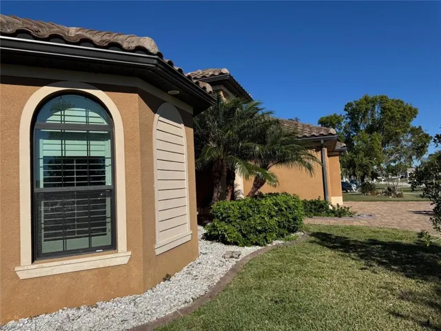 View of side of home with a lawn
