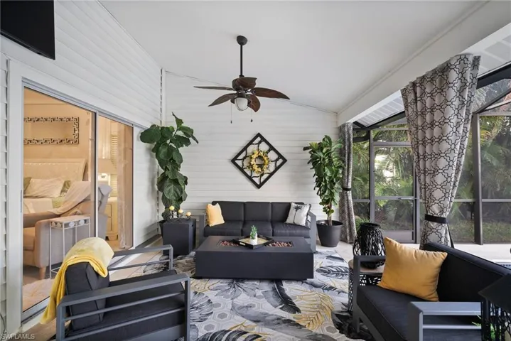 Sunroom featuring lofted ceiling and ceiling fan
