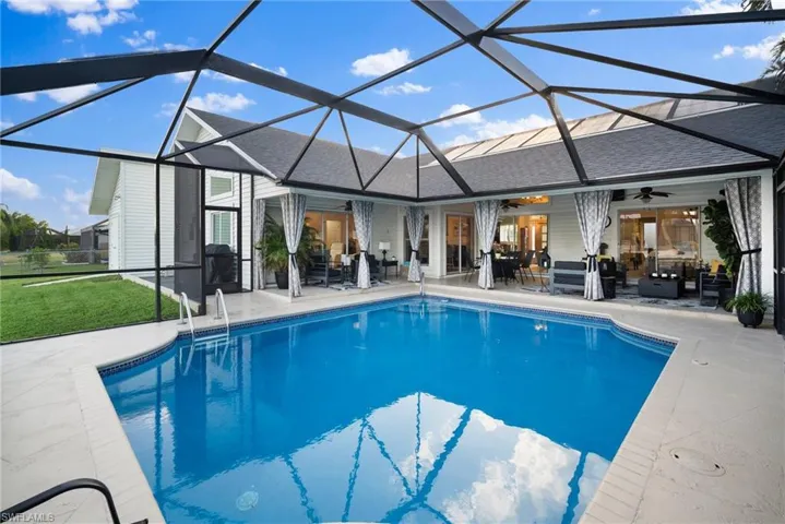 View of swimming pool with a patio area, a lanai, and ceiling fan