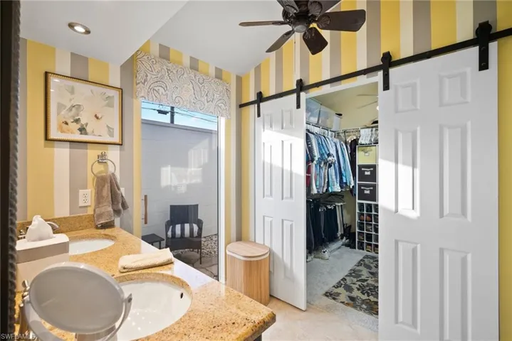Bathroom with ceiling fan, vanity, and tile patterned floors