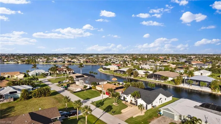 Birds eye view of property with a water view