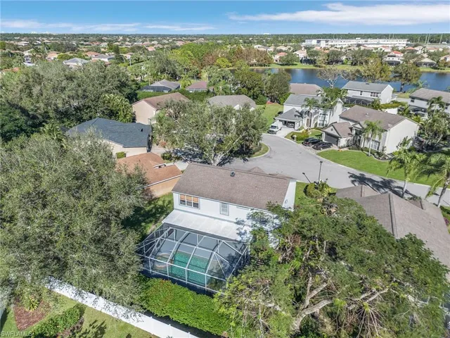 Birds eye view of property with a water view