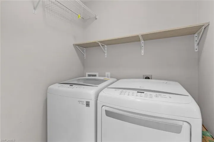 Clothes washing area featuring washing machine and clothes dryer