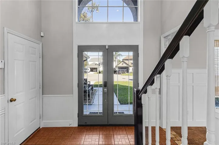 Entryway with french doors, a high ceiling, and plenty of natural light