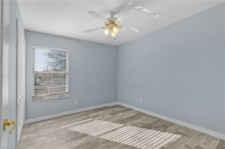 Unfurnished room with ceiling fan and light hardwood / wood-style floors