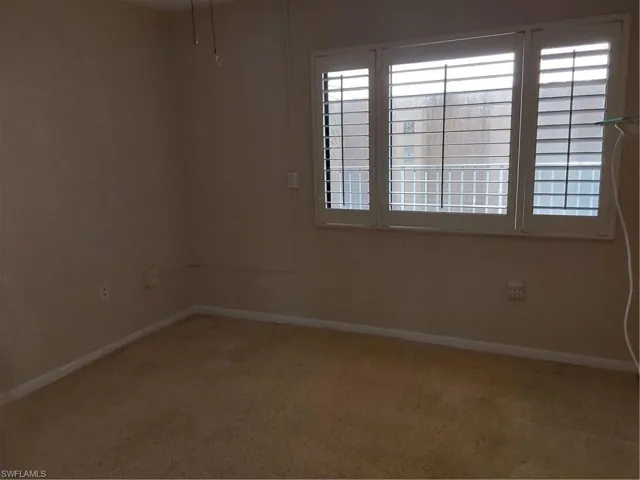 2nd bedroom with window and plantation shutters