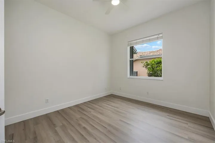 Bedroom with new floors and fan and natural light