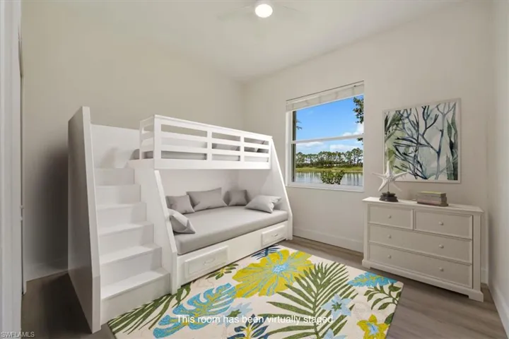 Virtually staged Bedroom with new floors and fan and natural light