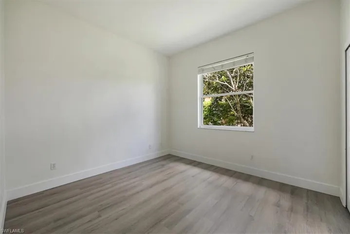 Bedroom with new floors and baseboards and natural light
