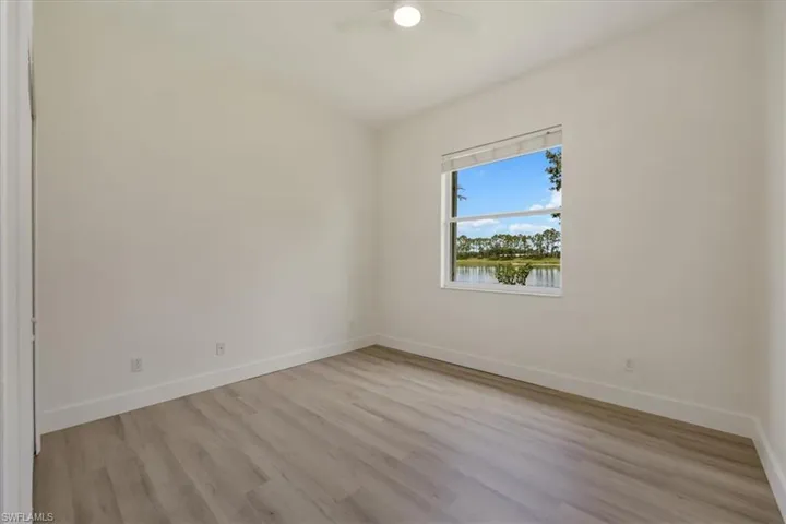 Bedroom with new floors and fan and natural light