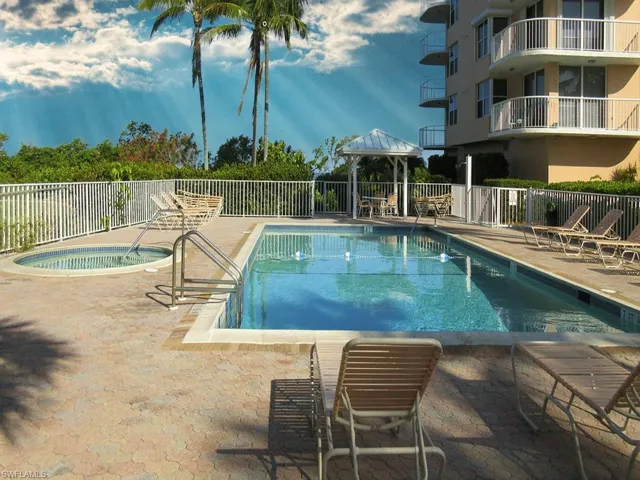 Community pool featuring a gazebo, a patio, and a hot tub