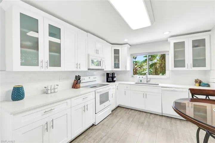 All new white shaker cabinet with light quartz countertops. Everything here from glasses, pots and pan ready to cook your fresh catch !