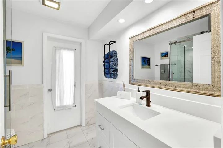 Master bath :Extra long vanity with quartz top and convenient access to the pool.