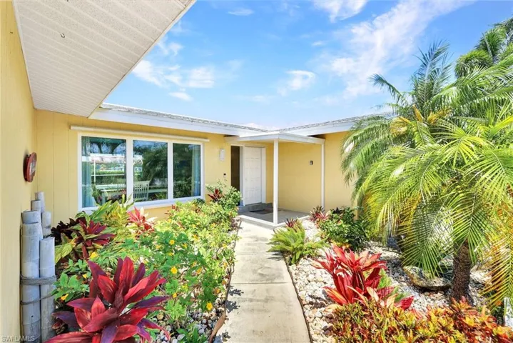 Tropical, colorful landscaping greets you at your entry.