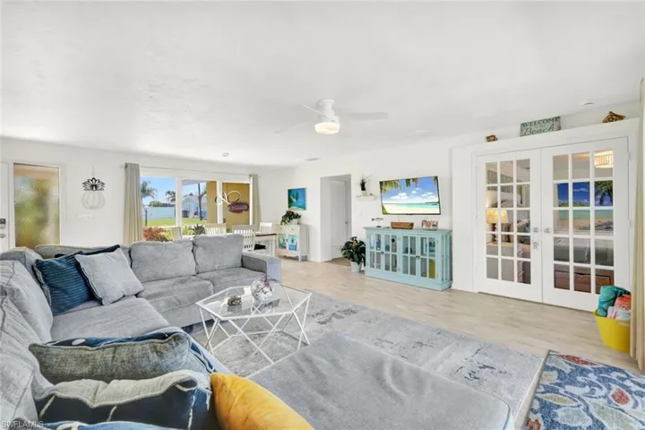 Living room with comfy deep sectional with coastal accents that say" hi SW florida ,I'm on vacation ?