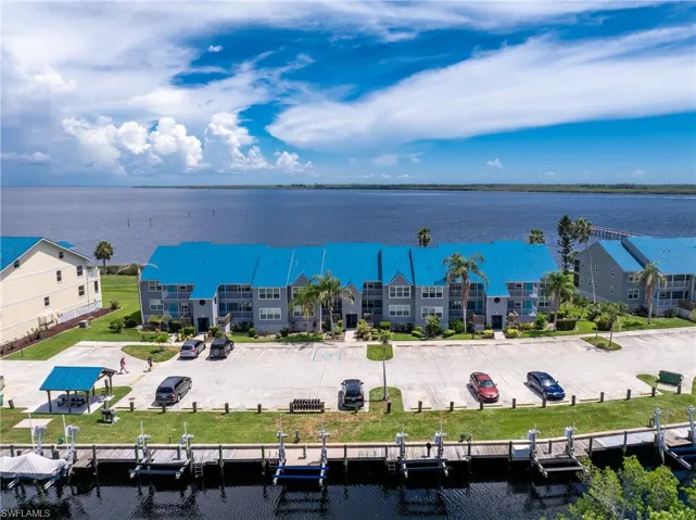 Aerial view of a pool and a nearby body of water
