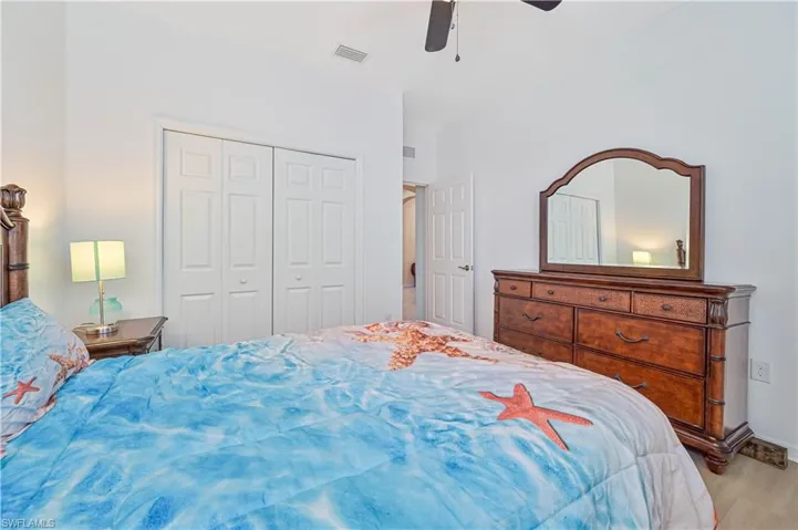 Bedroom featuring light hardwood / wood-style floors, ceiling fan, and a closet