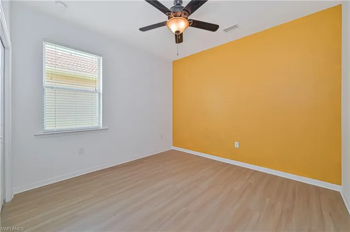 Unfurnished room featuring ceiling fan and light wood-type flooring