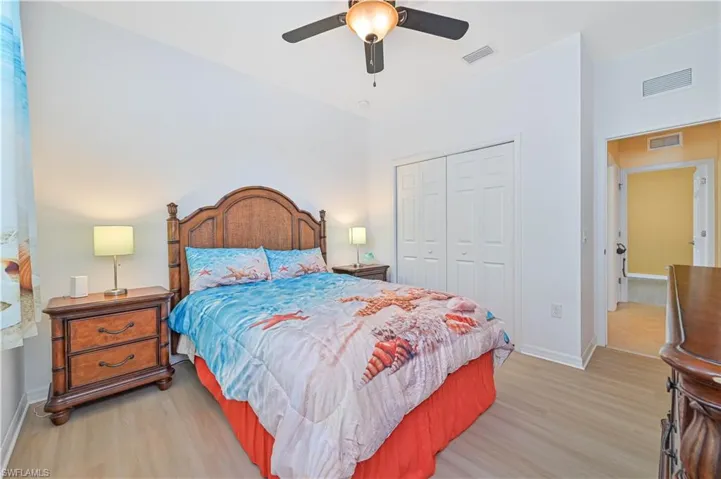 Bedroom featuring ceiling fan, a closet, and light hardwood / wood-style flooring