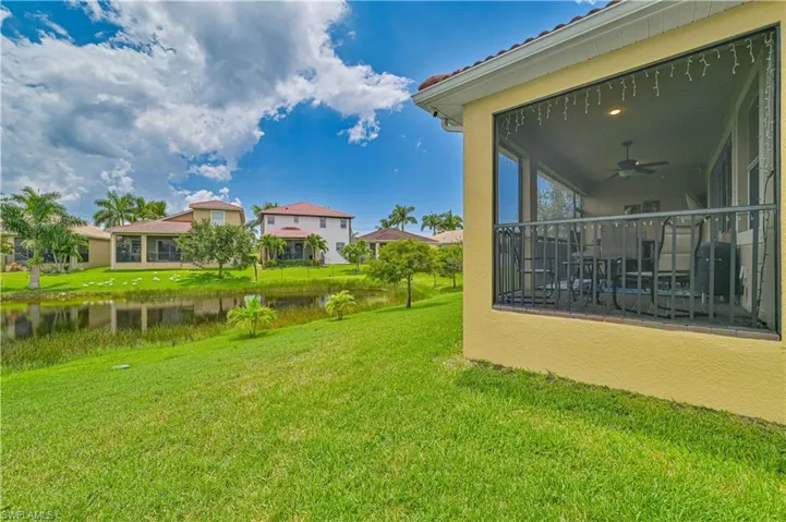 View of yard featuring a water view and ceiling fan