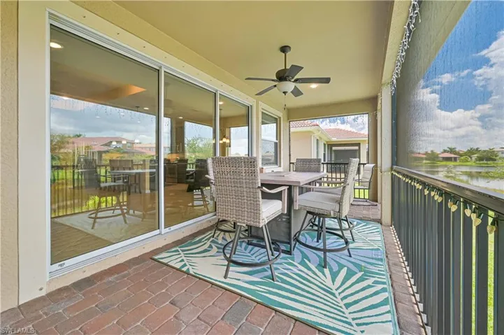 Sunroom / solarium with a water view and ceiling fan