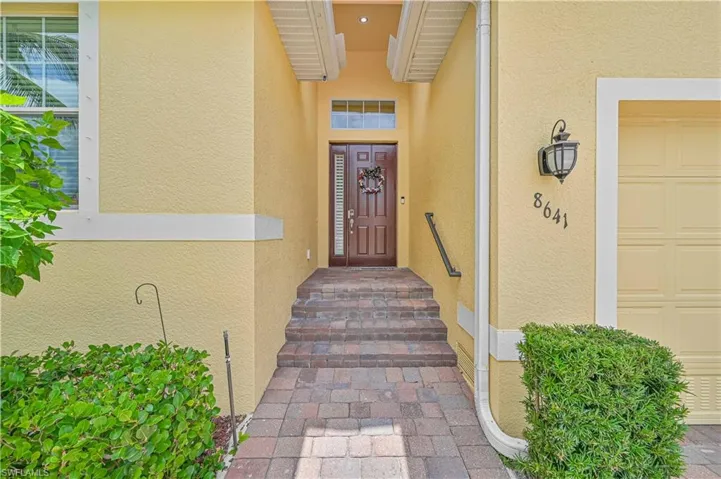 View of exterior entry with a garage