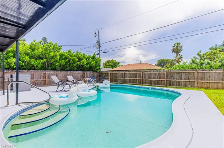 View of pool with a patio and a fenced backyard