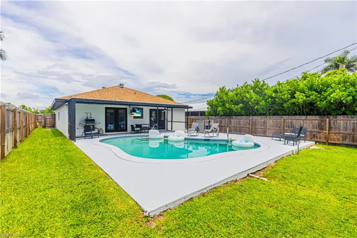 View of swimming pool featuring a patio, a fenced backyard, and french doors